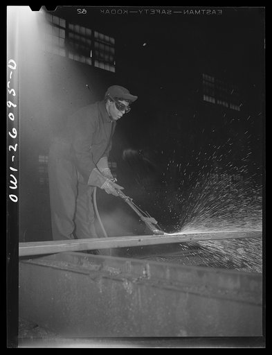 Untitled photo, possibly related to: Buffalo, New York. Gladys Chase, thirty-five, was a beautician for thirteen years before becoming a scarfer. Scarfing is the removing of breaks, seams, cracks, lap wells and defects from steel billets by the use of a burning torch and takes six months to learn th