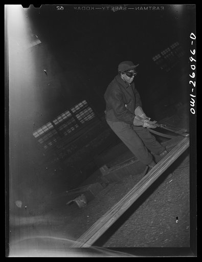 Untitled photo, possibly related to: Buffalo, New York. Gladys Chase, thirty-five, was a beautician for thirteen years before becoming a scarfer. Scarfing is the removing of breaks, seams, cracks, lap wells and defects from steel billets by the use of a burning torch and takes six months to learn th