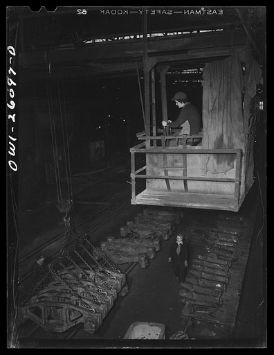 Buffalo, New York. Symington-Gould, makers of tank, ship and railroad parts. Woman operator of a five ton crane picking up rough castings of truck train for railroads. She operated this same crane in the last war; in between was a housewife