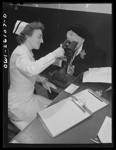 Buffalo, New York. After being interviewed as to past history and work qualifications, Mabel Goodwin is given an eye test at the employment office of the Bell Aircraft plant. She worked in a factory in the last war, and has since been a housewife and has two children over fourteen
