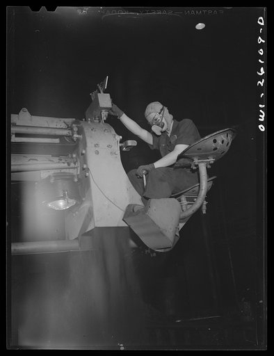 Buffalo, New York. Symington-Gould, makers of tank, ship and railroad parts. Sand slinger operated by a woman. Sand is forced onto pattern with air pressure. The operator wears safety goggles and a dust-proof noseguard to protect herself from ricocheting sand and must rest every twenty minutes or so