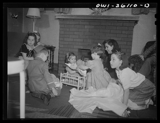 Untitled photo, possibly related to: Buffalo, New York. Mrs. Grimm, a twenty-six year old widow, with six children under twelve, is a crane operator in a war plant. Her two youngest children live in a foster home during the week. Their foster mother, Mrs. Hehr, gave a birthday party for Mona, two