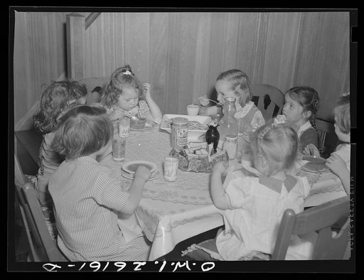 Untitled photo, possibly related to: Washington, D.C. A day nursery for pre-school children of mothers engaged in war work, operated under the supervision of the District of Columbia Health Department by Mrs. Leroy Bonbrest, at her home at 1144 Branch Avenue, S.E. The children eating their lunch