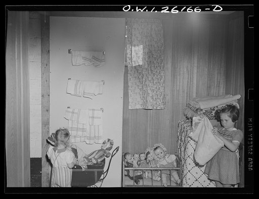 Washington, D.C. A day nursery for pre-school children of mothers engaged in war work, operated under the supervision of the District of Columbia Health Department by Mrs. Leroy Bonbrest at her home at 1144 Branch Avenue, S.E. Mrs. Two little girls learning a little about orderliness