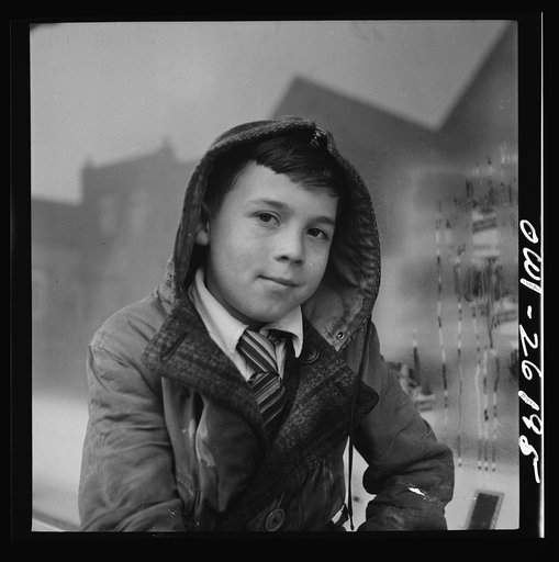Buffalo, New York. Peter Grimm, age ten, waiting with his wagon outside Loblaw's grocery store for customers to ask him to deliver their groceries. This was a rainy day with few customers. Sometimes Peter makes as much as three dollars on a Saturday. He pays for all his school supplies and much of h