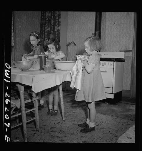 Buffalo, New York. The Grimm children doing the housework. Their mother, a twenty-six year old widow, is a crane operator at Pratt and Letchworth