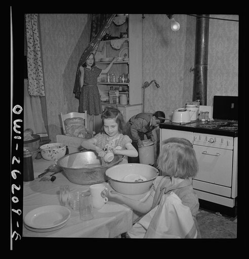 Buffalo, New York. Patsy Grimm helping to do all the housework.  Their mother, a twenty-six year old widow, is a crane operator at Pratt and Letchworth