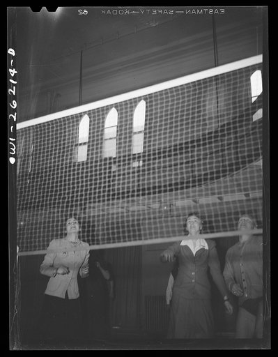 Untitled photo, possibly related to: Buffalo, New York. Playing volleyball at Young Women's Christian Association (YWCA) coeducational recreation program for third shift and swing shift workers from 9 a.m. to 1 and midnight to 5 a.m.; includes sports, singing and dancing