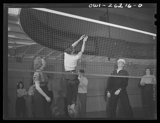 Untitled photo, possibly related to: Buffalo, New York. Playing volleyball at Young Women's Christian Association (YWCA) coeducational recreation program for third shift and swing shift workers from 9 a.m. to 1 and midnight to 5 a.m.; includes sports, singing and dancing