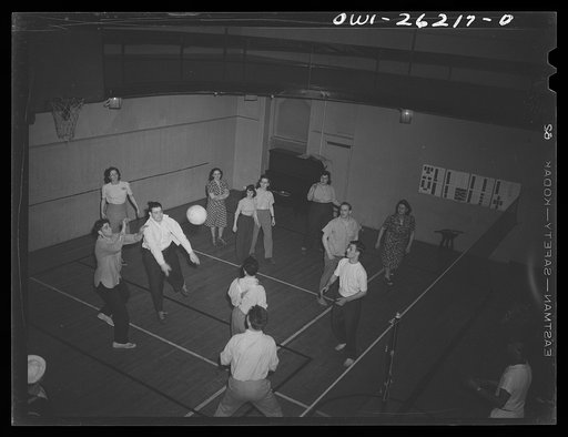 Untitled photo, possibly related to: Buffalo, New York. Playing volleyball at Young Women's Christian Association (YWCA) coeducational recreation program for third shift and swing shift workers from 9 a.m. to 1 and midnight to 5 a.m.; includes sports, singing and dancing