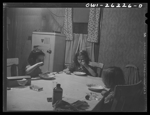 Untitled photo, possibly related to: Buffalo, New York. Beverly Ann, eleven, Mary, eight, and Patsy Grimm six, eating lunch of canned chicken soup and omelette which Beverly Ann prepared. Their mother, a twenty-six year old widow, is a crane operator at Pratt and Letchworth