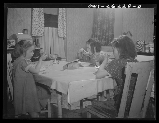 Buffalo, New York. Beverly Ann, eleven, Mary, eight, and Patsy Grimm six, eating lunch of canned chicken soup and omelette which Beverly Ann prepared. Their mother, a twenty-six year old widow, is a crane operator at Pratt and Letchworth
