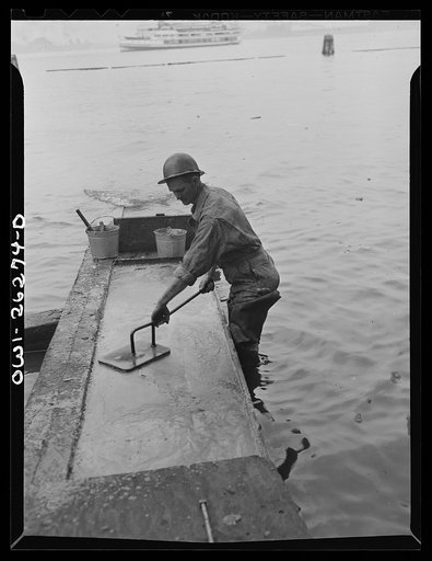 Bethlehem-Fairfield shipyards, Baltimore, Maryland. Preparations for launching a ship. Preparing the shipways with tallow