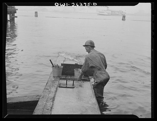 Bethlehem-Fairfield shipyards, Baltimore, Maryland. Preparations for launching a ship. Preparing the shipways with tallow