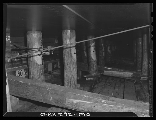 Bethlehem-Fairfield shipyards, Baltimore, Maryland. Preparations for launching a ship. Poppins underneath the ship
