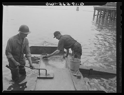 Bethlehem-Fairfield shipyards, Baltimore, Maryland. Preparations for launching a ship. Putting tallow on the shipways