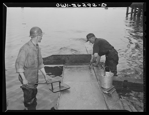 Bethlehem-Fairfield shipyards, Baltimore, Maryland. Preparations for launching a ship. Putting tallow on the shipways