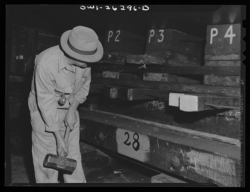Bethlehem-Fairfield shipyards, Baltimore, Maryland. Preparations for launching a ship. Driving a wedge