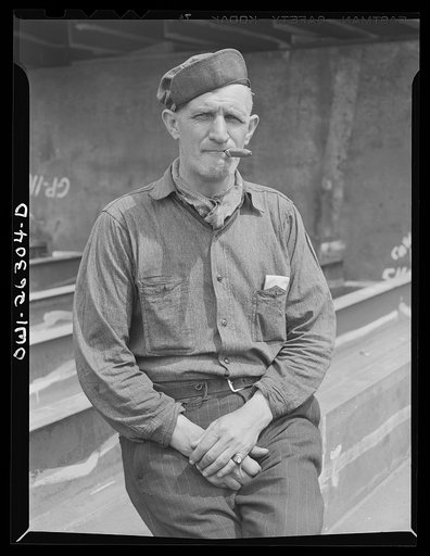 Bethlehem-Fairfield shipyards, Baltimore, Maryland. Train worker with a cigar