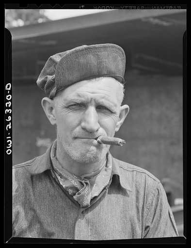 Bethlehem-Fairfield shipyards, Baltimore, Maryland. Trainman with a cigar