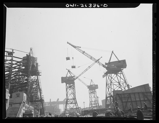 Bethlehem-Fairfield shipyards, Baltimore, Maryland. Cranes lifting various materials