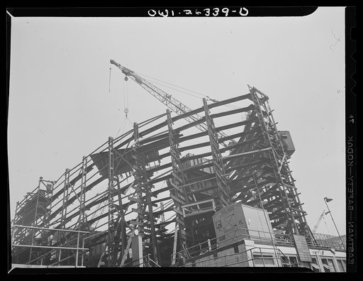 Bethlehem-Fairfield shipyards, Baltimore, Maryland. Lifting plate sections onto a ship