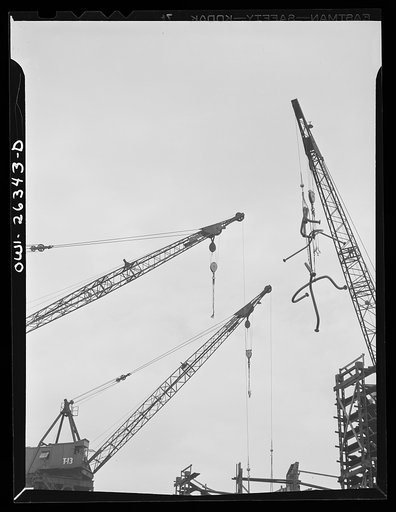 Bethlehem-Fairfield shipyards, Baltimore, Maryland. Crane lifting pipe section