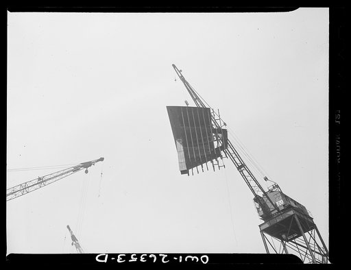Bethlehem-Fairfield shipyards, Baltimore, Maryland. Lifting a ship section