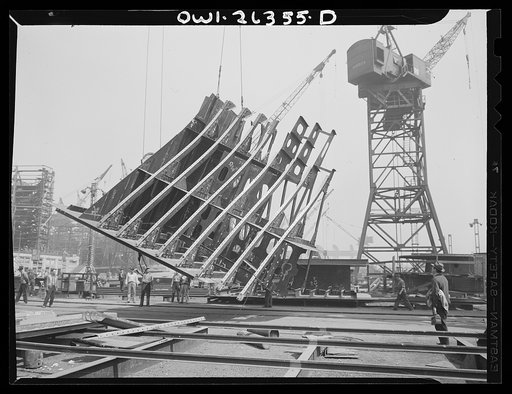 Bethlehem-Fairfield shipyards, Baltimore, Maryland. Lifting a ship section
