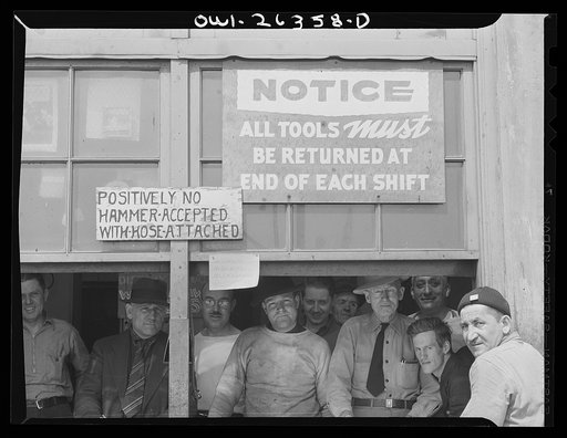 Bethlehem-Fairfield shipyards, Baltimore, Maryland. Toolroom signs and workers