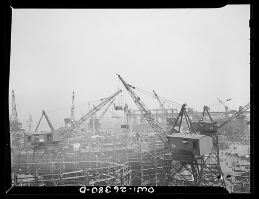Bethlehem-Fairfield shipyards, Baltimore, Maryland. Cranes lowering the electric motors on the ships