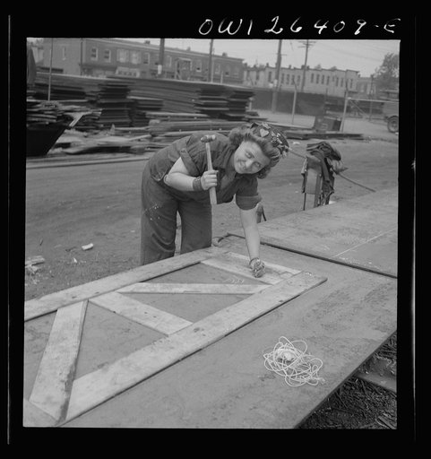 Bethlehem-Fairfield shipyards, Baltimore, Maryland. Punching down the wooden templates to mark out the steel