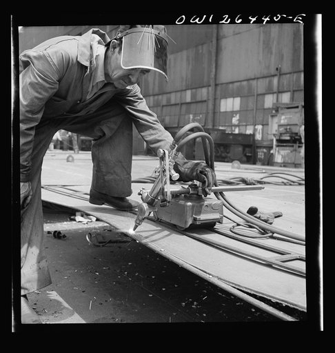 Bethlehem-Fairfield shipyards, Baltimore, Maryland. Burning off excess steel plate