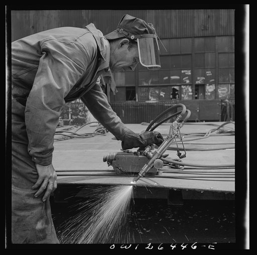 Bethlehem-Fairfield shipyards, Baltimore, Maryland. Burning off excess steel plate