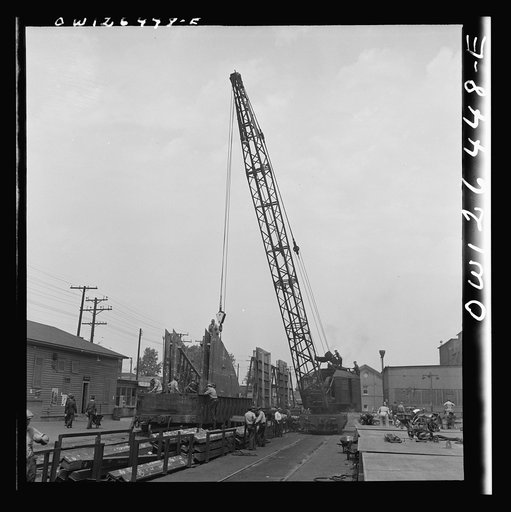 Bethlehem-Fairfield shipyards, Baltimore, Maryland. Transferring a steel section from the fabricating table to a railroad car