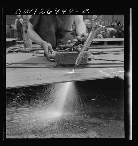 Bethlehem-Fairfield shipyards, Baltimore, Maryland. Cutting a steel section from a plate