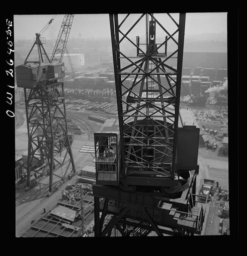 Bethlehem-Fairfield shipyards, Baltimore, Maryland. A crane operator high above the yard