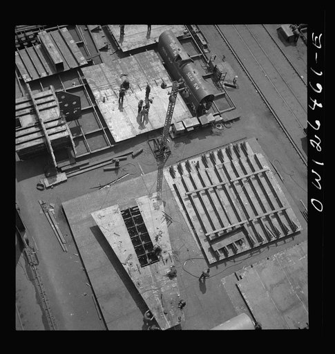 Bethlehem-Fairfield shipyards, Baltimore, Maryland. Transferring fabricated sections to the ship