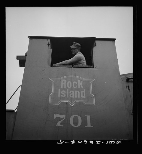Blue Island, Illinois. Engineer in the cab of a diesel switch engine on the Chicago and Rock Island Railroad