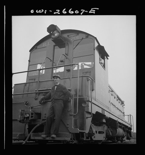 Blue Island, Illinois. Switchman riding the footboard of a diesel switch engine on the Chicago and Rock Island Railroad