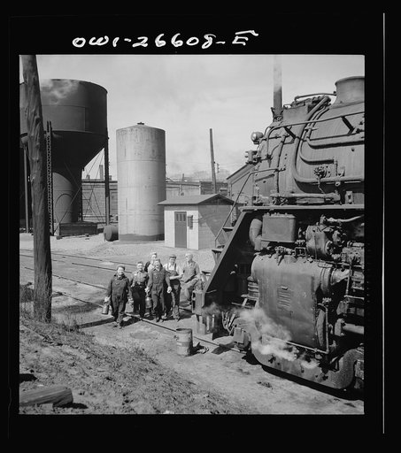 Untitled photo, possibly related to: Clinton, Iowa. Women wipers of the Chicago and Northwestern Railroad going out to work on an engine at the roundhouse