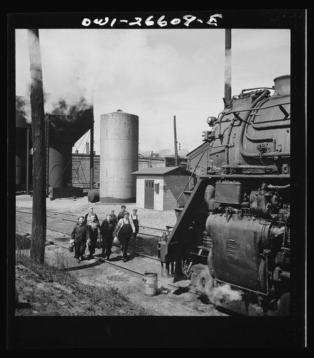 Clinton, Iowa. Women wipers of the Chicago and Northwestern Railroad going out to work on an engine at the roundhouse