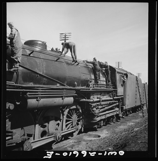 Clinton, Iowa. Women wipers of the Chicago and Northwestern Railroad going out to work on an engine at the roundhouse