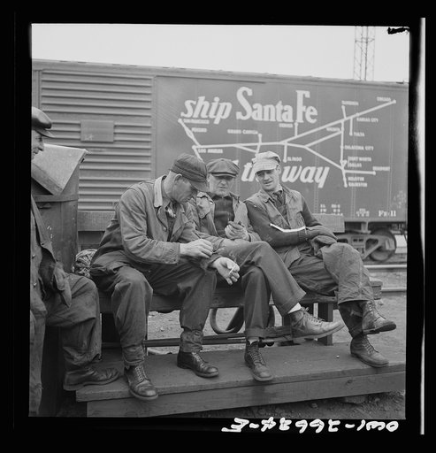 Cicero, Illinois. Switchmen discussing their switch lists at the Clyde yard of the Chicago, Burlington and Quincy Railroad