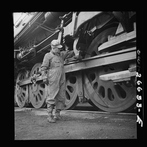Cicero, Illinois. Engineer of the Chicago, Burlington and Quincy Railroad oiling his engine before going out from the Clyde yard on a run
