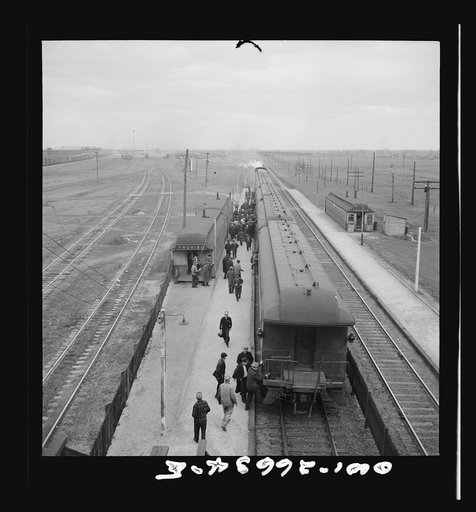 Chicago, Illinois. Workmen at the Proviso yard of the Chicago and Northwestern Railroad taking the suburban train for home