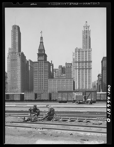 Chicago, Illinois. Welders working on one of the tracks at the South Water Street freight terminal of the Illinois Central Railroad