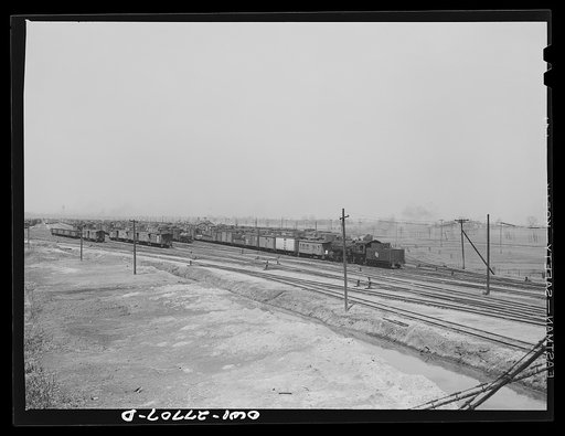 Untitled photo, possibly related to: Bensenville, Illinois. A redball west coast freight train leaving the Bensenville yard of the Chicago, Milwaukee, Saint Paul and Pacific Railroad