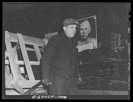 Untitled photo, possibly related to: Chicago, Illinois. A freight handler at work at the United States Army consolidating station