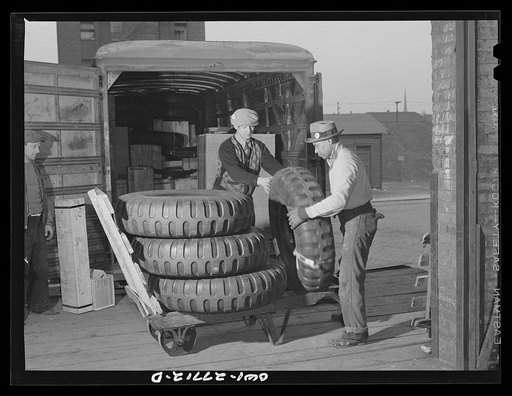 Chicago, Illinois. Tires being unloaded from a truck at the United States Army consolidating station